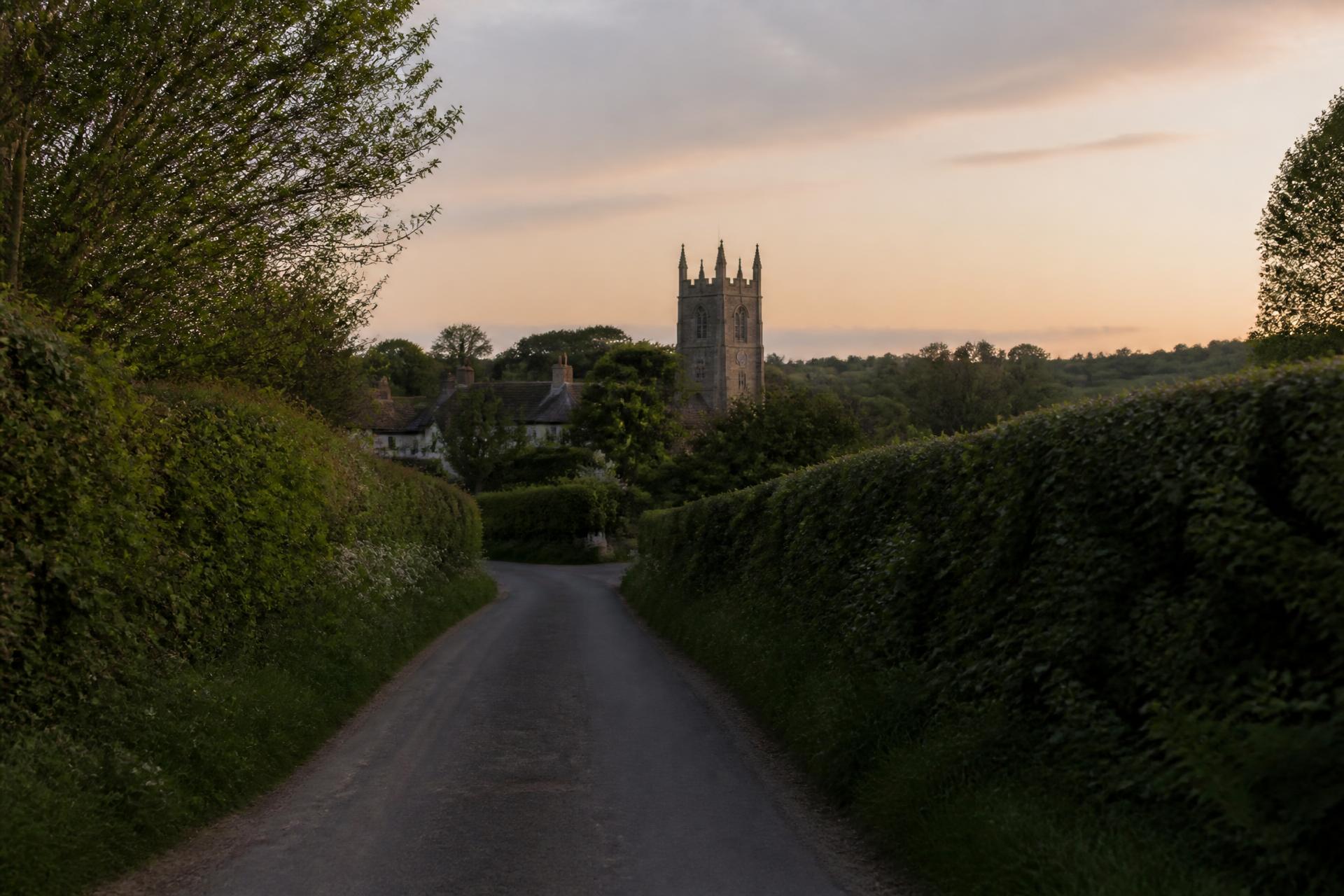 Country lane winding through green fields